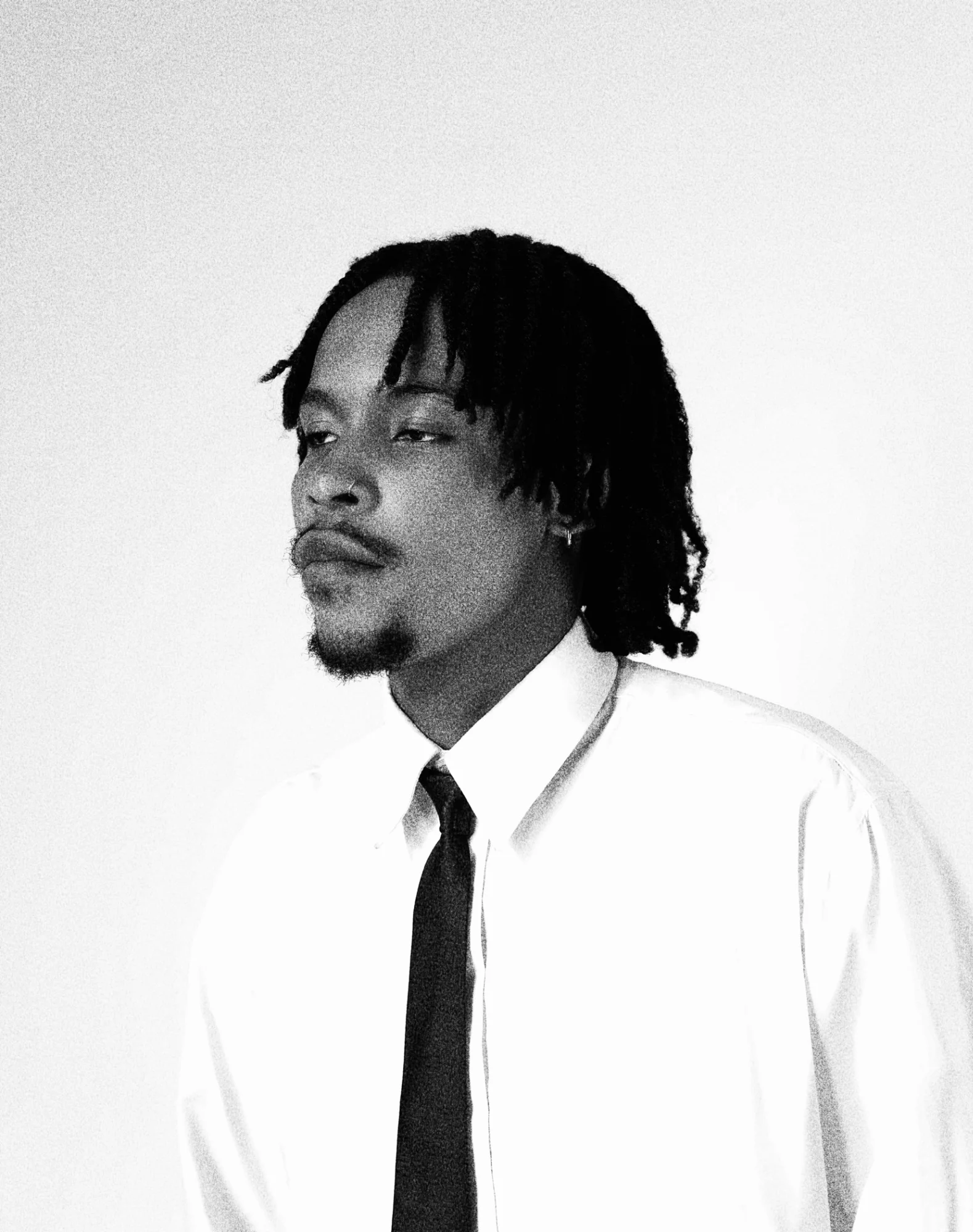 Profile portrait of HIGHBREED in a white shirt and tie